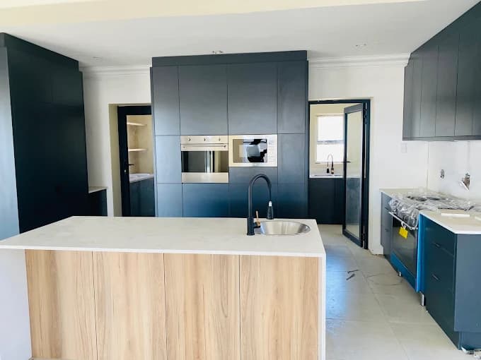 Modern kitchen cabinetry and island completed by Dawgthemba Construction